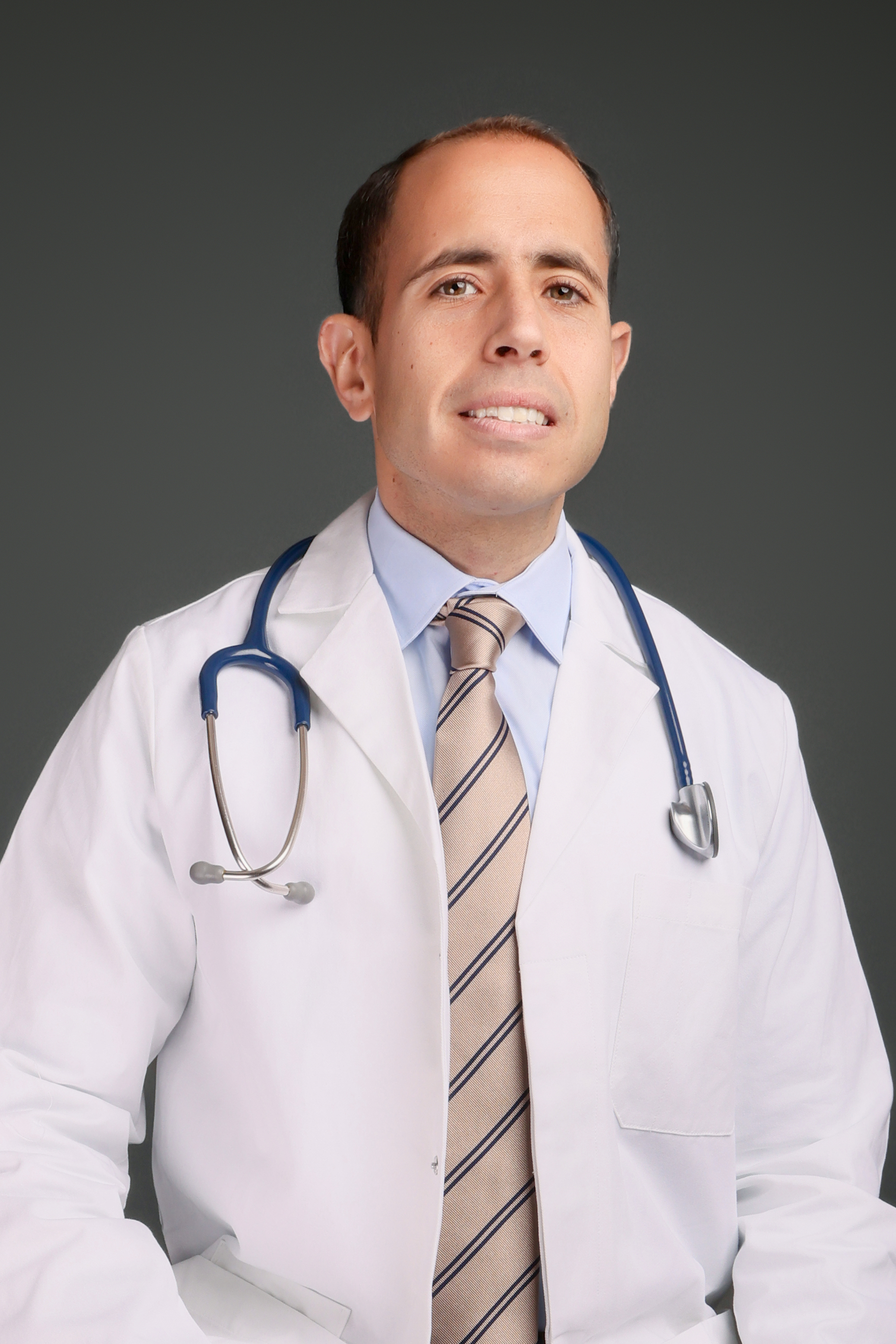 Dr. Ahmad Ammous in clinical attire